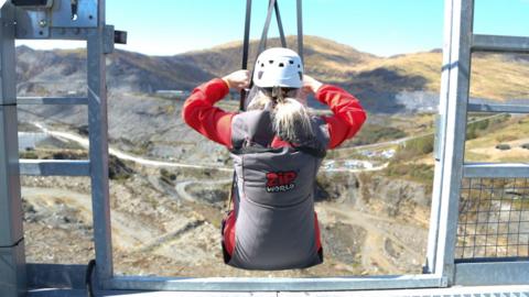 Person in Zip World harness