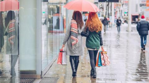 Shoppers in the rain