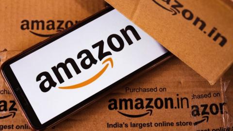 Image of Amazon logo with delivery boxes.