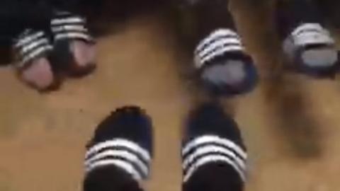 The men's feet in their flip flops