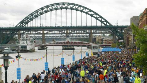 Spectators gather for the Great North Run by the Tyne bridge