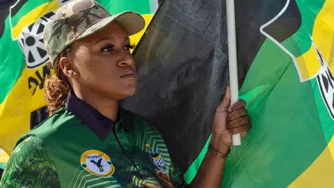 A woman holding an ANC flag during a rally in Soweto, South Africa - 25 May 2024