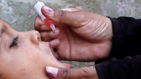 Boy receives polio vaccine drops in Karachi, Pakistan, on 9 April 2018