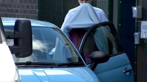 Katie Price entering car with blanket over head