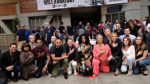 The cast of Grey's Anatomy kneeling