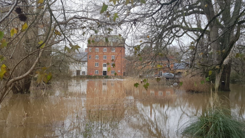 The Mill at Elstead, near Godalming, on the banks of the swollen River Wey