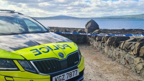 Police car and tape at Cultra beach