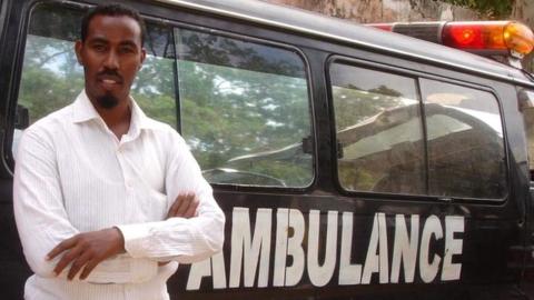 Abdulkadir Abdirahman Adan standing against an ambulance