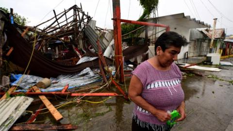 Martha Sanchez reacts while walking in front of her souvenir store that was destroyed when Hurricane Grace slammed into the coast with torrential rains, in Costa Esmeralda, near Tecolutla, Mexico, 21 August 2021