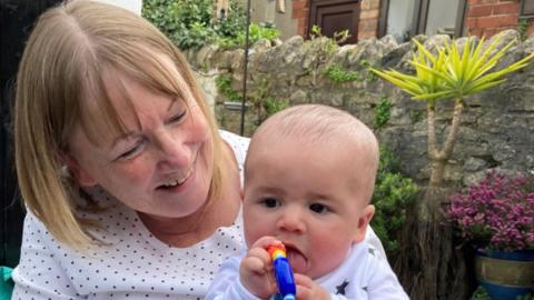 Grandmother Ann Phillips with grandson Theo