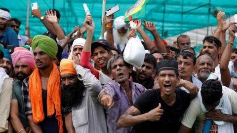 People shout slogans during a Maha Panchayat or grand village council meeting as part of a farmers" protest against farm laws in Muzaffarnagar in the northern state of Uttar Pradesh, India,