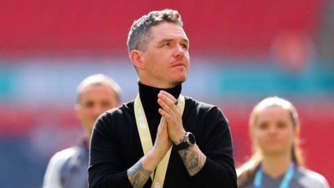 Manchester United manager Marc Skinner wearing an FA Cup winners' medal
