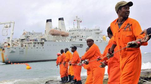 Workers haul a fibre-optic cable, which will serve East Africa, to shore at the Kenyan port town of Mombasa in 2009