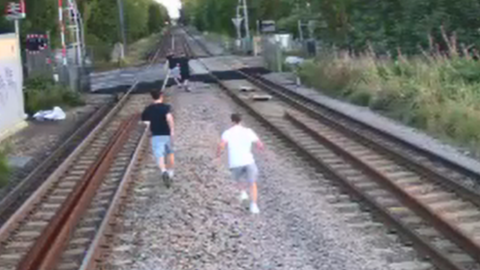 Children running along tracks