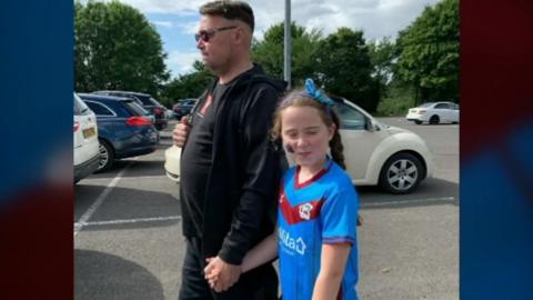 Dave with daughter Sydney wearing the shirt she was given for her eighth birthday