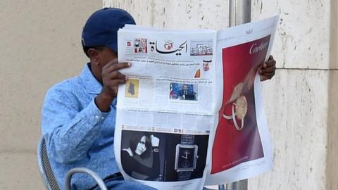 A man reading Al-Hayat newspaper at a cafe in the Saudi capital Riyadh