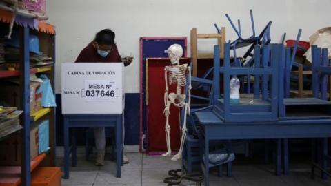 A voter casts a ballot at polling station set up in a school in Lima, Peru. Photo: 6 June 2021