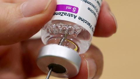 A medical worker prepares a dose of Oxford/AstraZeneca's COVID-19 vaccine at a vaccination centre in Antwerp, Belgium March 18, 2021