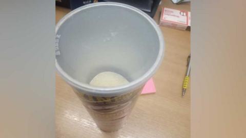 Half-eaten tin of Pringles