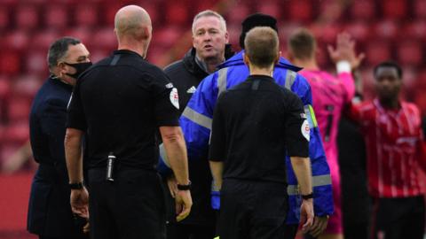 Ipswich Town manager Paul Lambert speaks to Referee Kevin Johnson following defeat by Lincoln