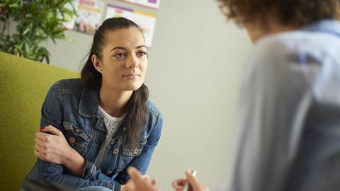 Young woman sat with advisor