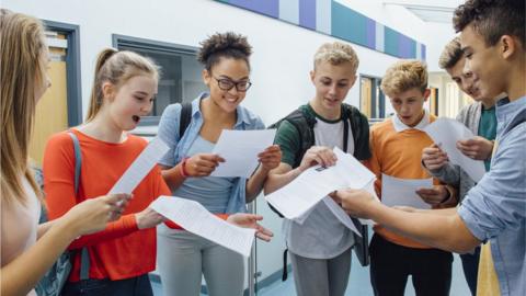 school children read positive exam results