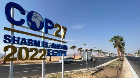 View of a COP27 sign on the road leading to the conference area in Egypt's Red Sea resort of Sharm el-Sheikh town