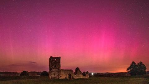 Knowlton church with northern lights in the sky