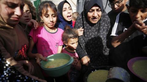 Displaced Palestinians share food in the Gaza Strip