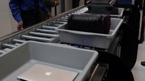 security conveyor belt, Mac laptop in tray