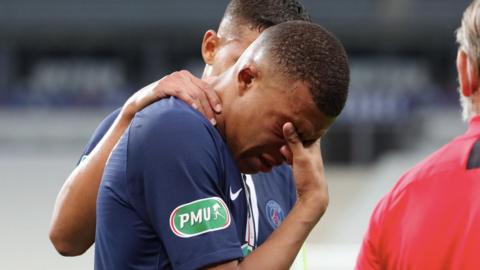 Kylian Mbappe with his head in his hands