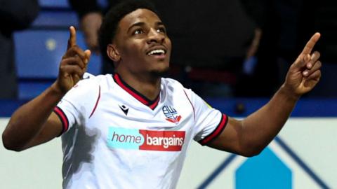 Dapo Afolayan celebrates scoring for Bolton against Cambridge United