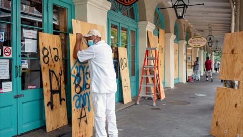 City of New Orleans worker Louis Marrero boards up businesses in the French Quarter as the city braces for the arrival of Tropical Storm Sally in New Orleans, Louisiana, U.S., September 14, 2020