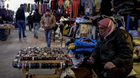 Syrians walk in a popular market in Manbij, northern Syria (31 December 2018)