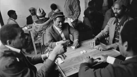 A group of men playing dominos at Leeds West Indian Centre, Laycock Place. Apr 1983