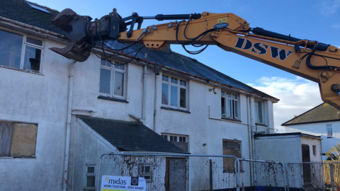 Digger starts demolishing house