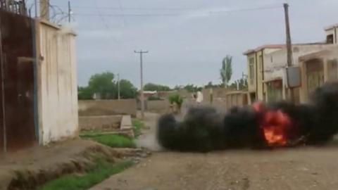 An explosion is seen during heavy firing between the Taliban and Afghan forces on the street in Kunduz