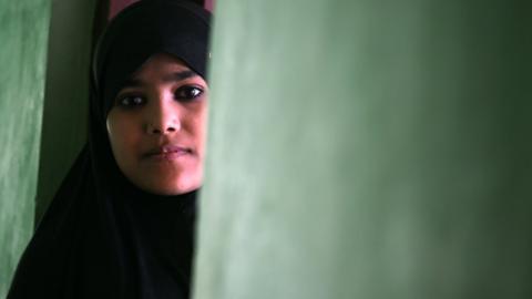 Rohingya refugee Yasmeen poses inside a building on the outskirts of Srinagar on September 14, 2017