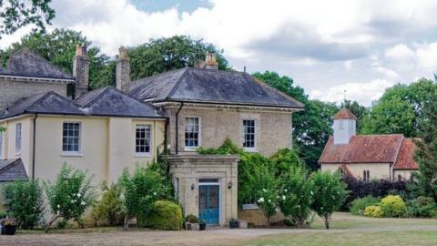 The rectory and church in distance