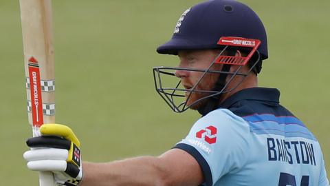 Jonny Bairstow raises his bat after reaching 50