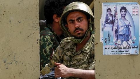 A Yemeni soldier loyal to the Shiite Huthi rebels sits in the back of an armoured vehicle during a military parade in the capital Sanaa on October 16, 2018