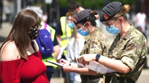 Combat medics from Queen Alexandra's Royal Army Nursing Corps vaccinate members of the public at a rapid vaccination centre