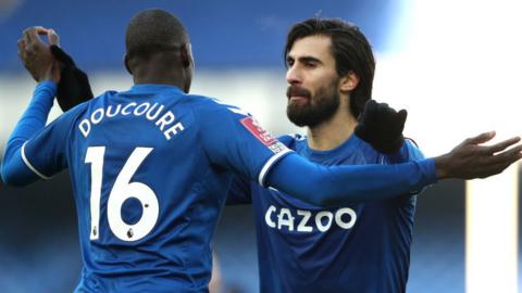 Abdoulaye Doucoure and Andre Gomes celebrate