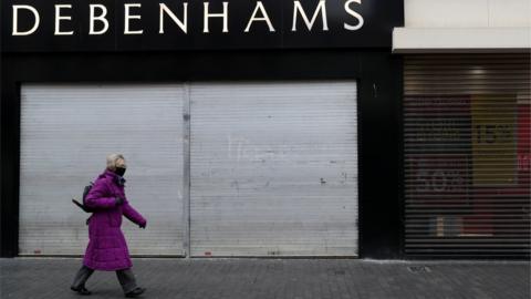 Woman walking past Debenhams in Middlesbrough Town Centre