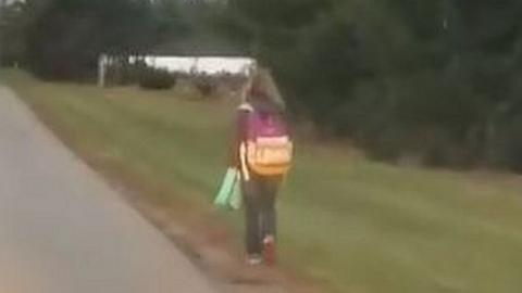 10 year old walking on road with backpack