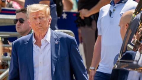 Republican presidential candidate and former U.S. President Donald Trump is directed to his vehicle after speaking at the Steer N' Stein bar at the Iowa State Fair