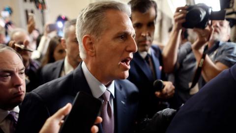 Speaker of the House Kevin McCarthy (R-CA) is surrounded by staff, security and journalists as he walks to the House Chamber ahead of a vote at the U.S. Capitol on October 03, 2023