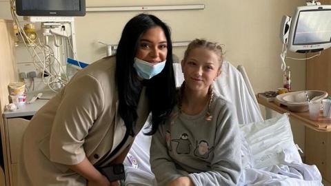 Afshan Azad poses with young patient