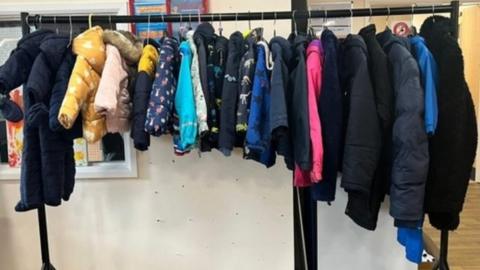 A clothes rail full of children's coats