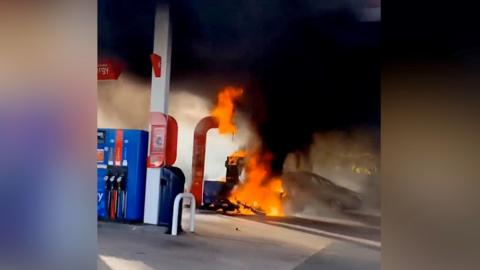 The motorbike on fire at the petrol station
